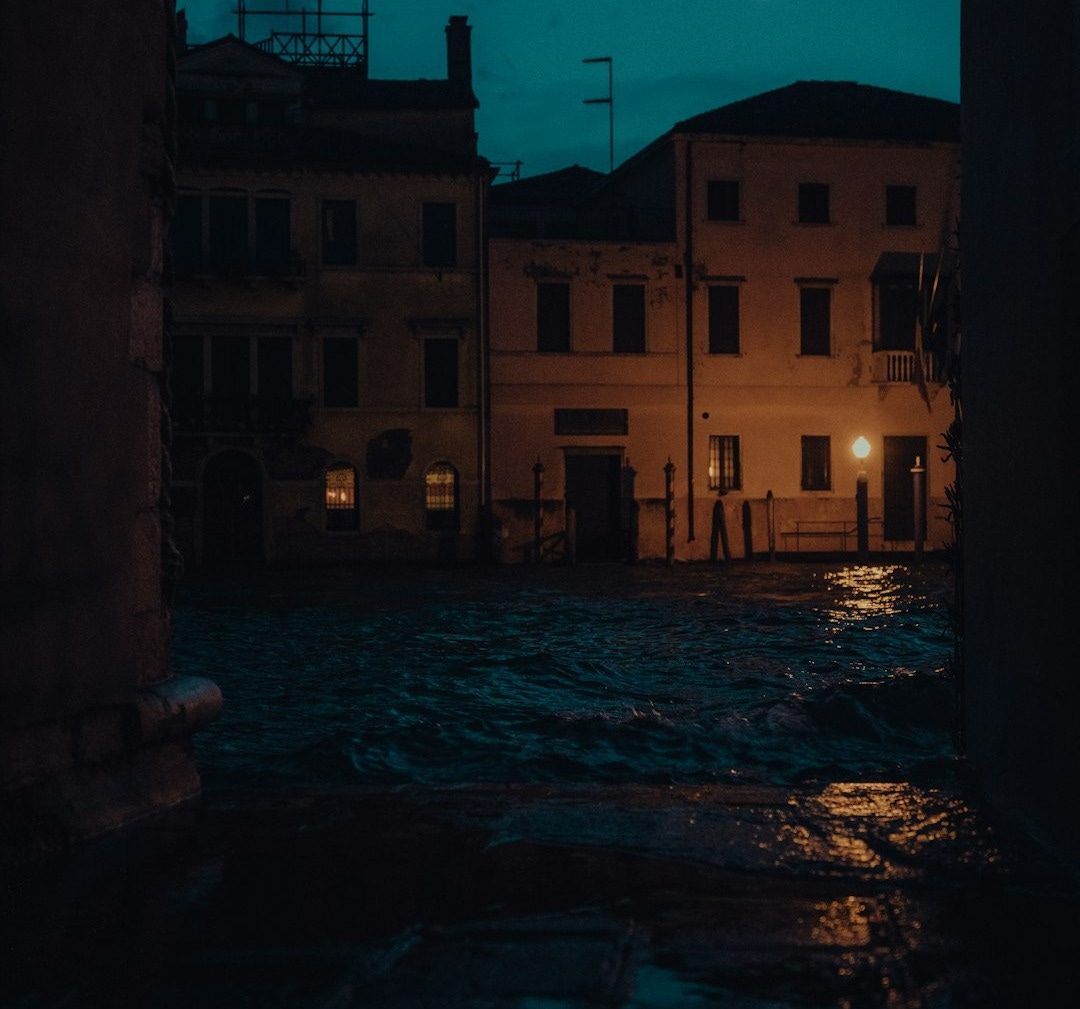 a street at night with a building in the background