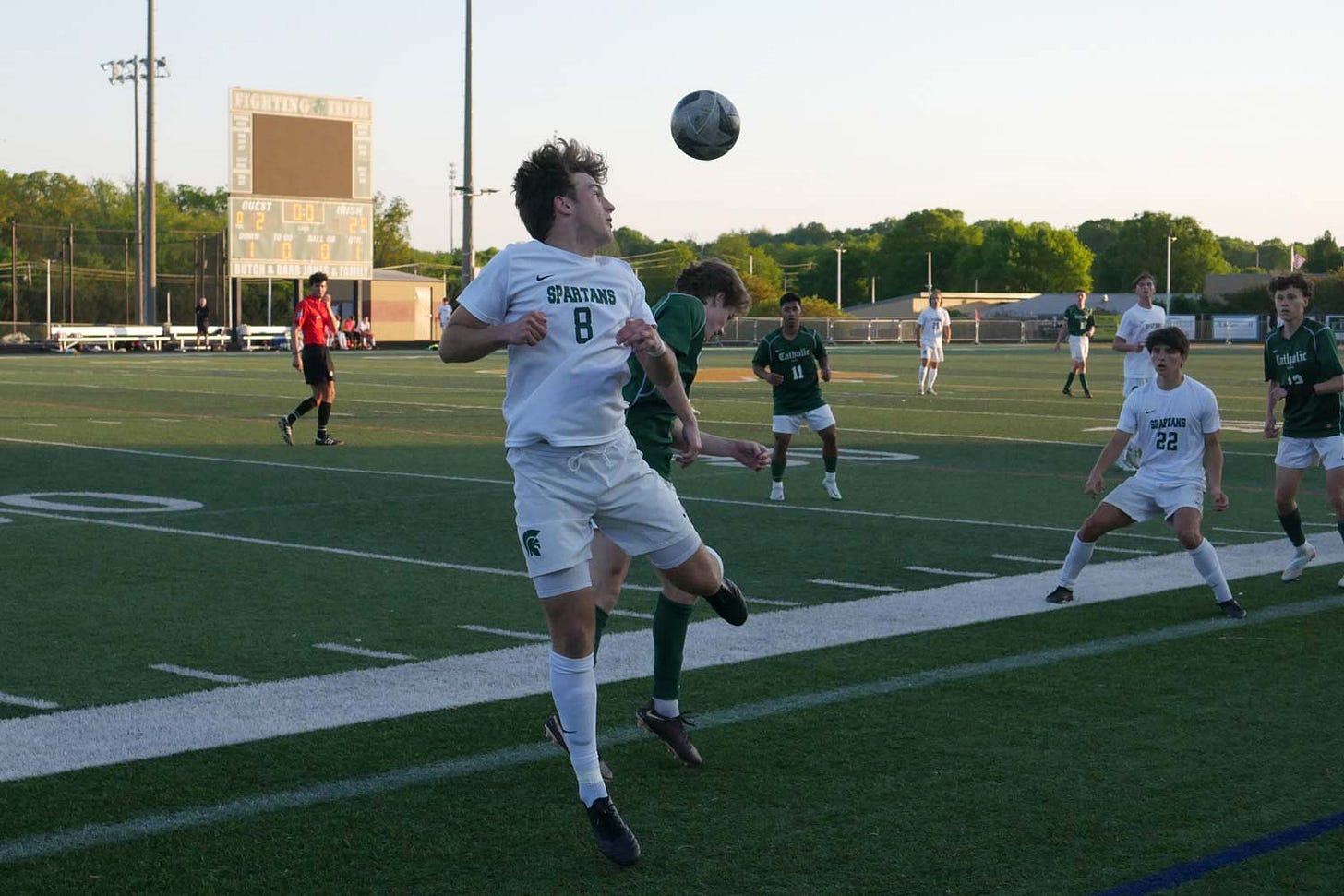 Webb and Catholic boys soccer players compete on the field.