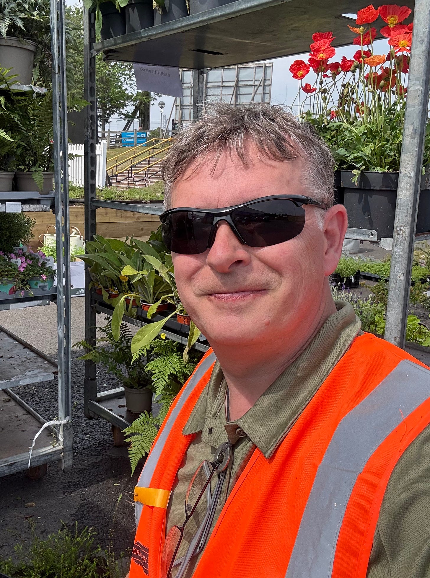 Gary Webb in a hi-vis vest posed in front of plant racks at BBC Gardeners' World Live Gary Webb in a hi-vis vest posed in front of plant racks at BBC Gardeners' World Live