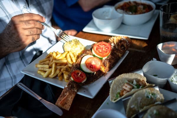 A close-up of Mr. Khan’s whole fish and French fries. A close-up of Mr. Khan’s whole fish and French fries.