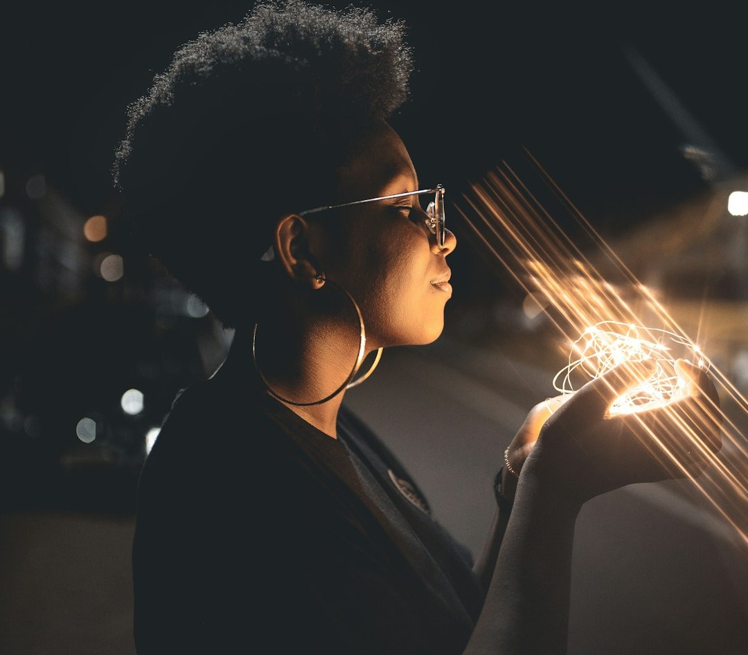 woman standing and holding string lights woman standing and holding string lights