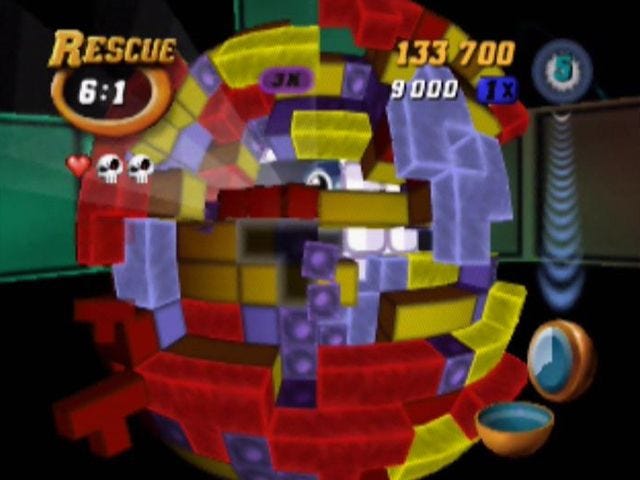 A screenshot from the Rescue mode of Tetrisphere, level 6-1, with the eye of the creature you're supposed to free from the inside of the sphere's core visible. A screenshot from the Rescue mode of Tetrisphere, level 6-1, with the eye of the creature you're supposed to free from the inside of the sphere's core visible.