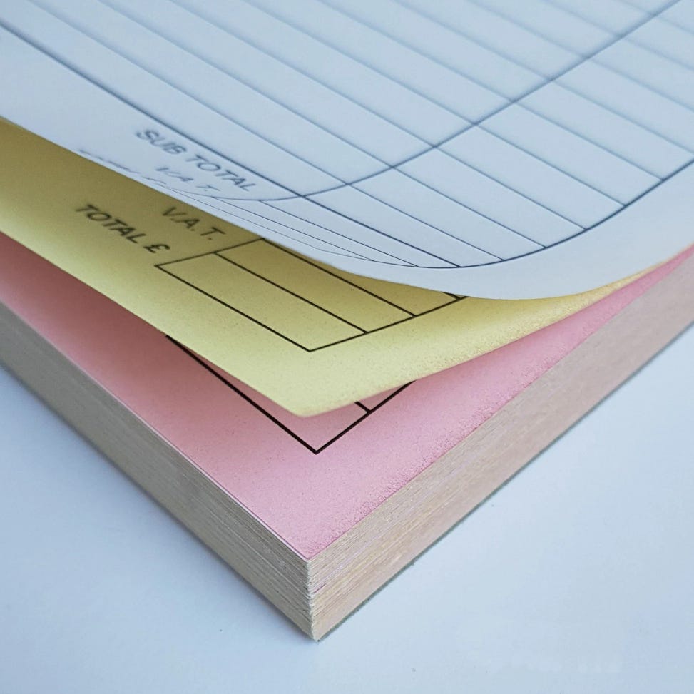 Photo of three pages in a triplicate pad, one white, one yellow, one pink. Photo of three pages in a triplicate pad, one white, one yellow, one pink.
