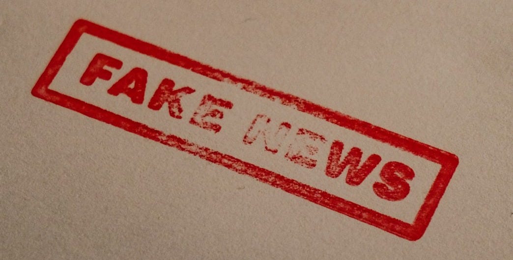 a stamp that reads fake news on a piece of paper