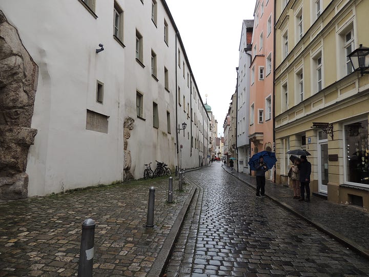 photos of buildings, a cathedral. a plaque, and a gravestone embedded in a wall