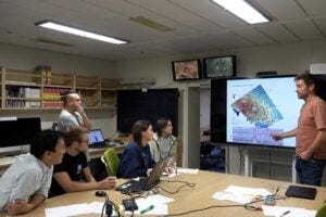 Dr Uisdean Nicholson presenting his findings to scientists on board a drilling ship.