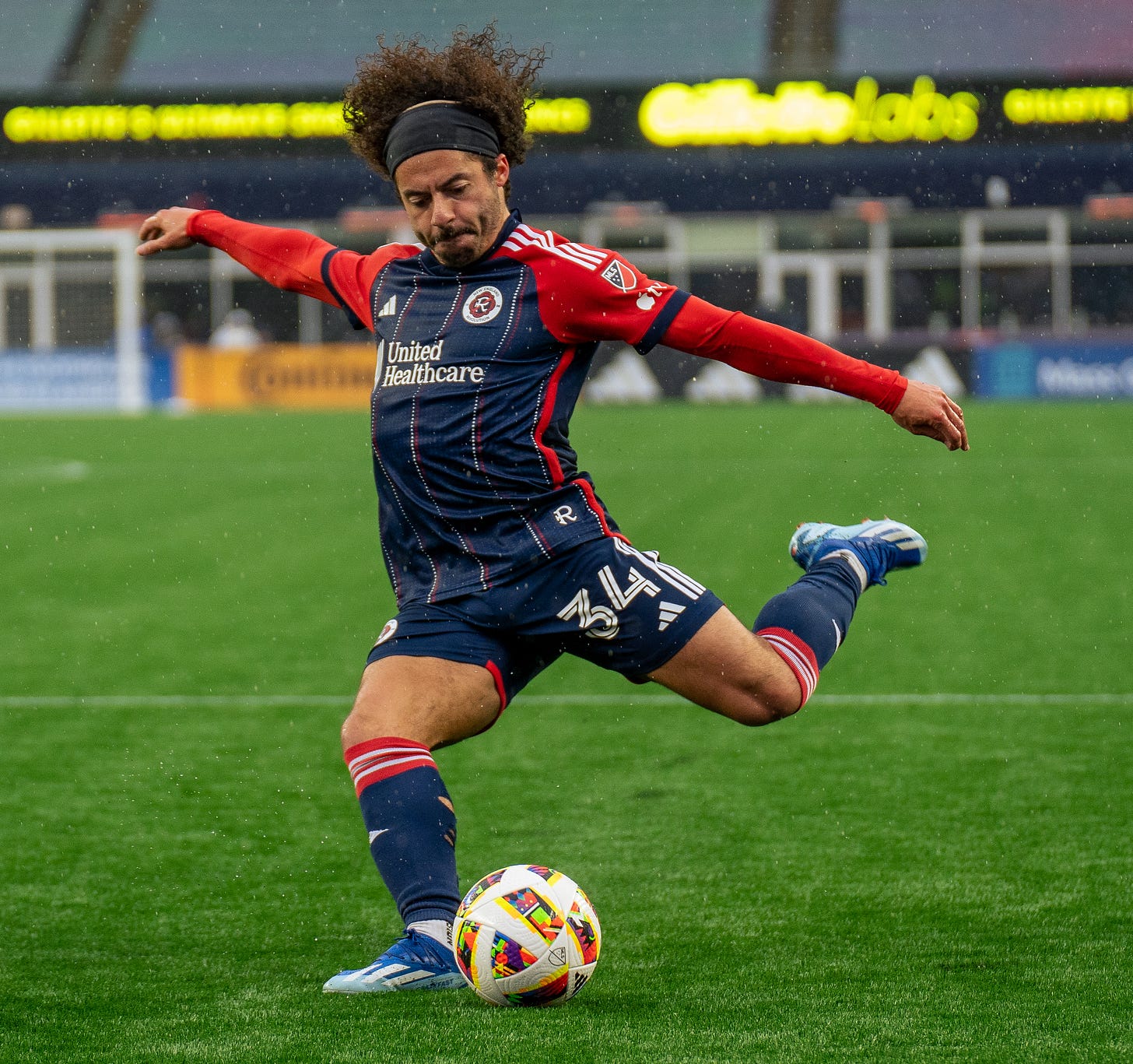Photo of New England Revolution left back Ryan Spaulding kicking a soccer ball