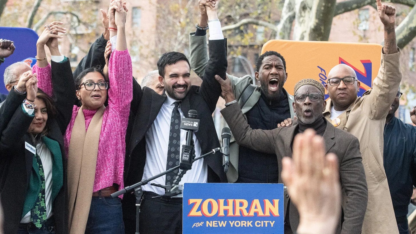 Zohran Mamdani, Democratic candidate for New York City mayor, holds hands with supporters during a campaign event in Queens on 1 November 2025, days before the election (Stephanie Keith/Getty Images/AFP)