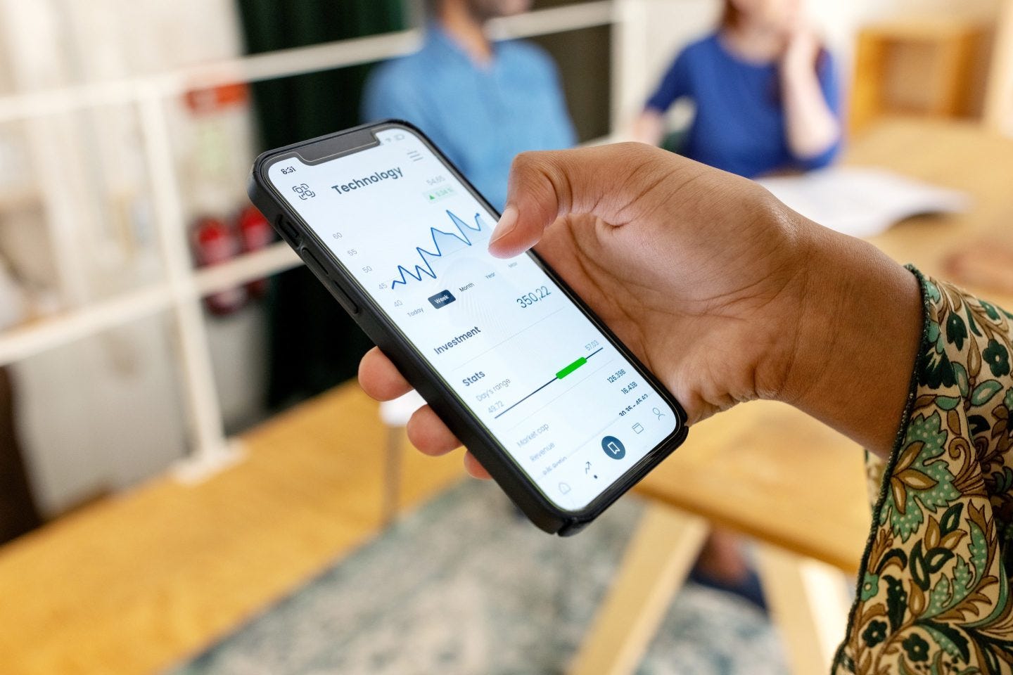 Retail investor checking technology stock trends on a mobile trading app