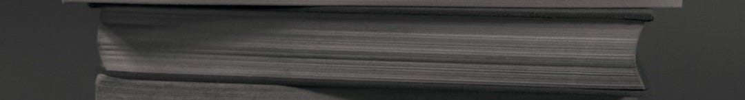 stack of books on black table