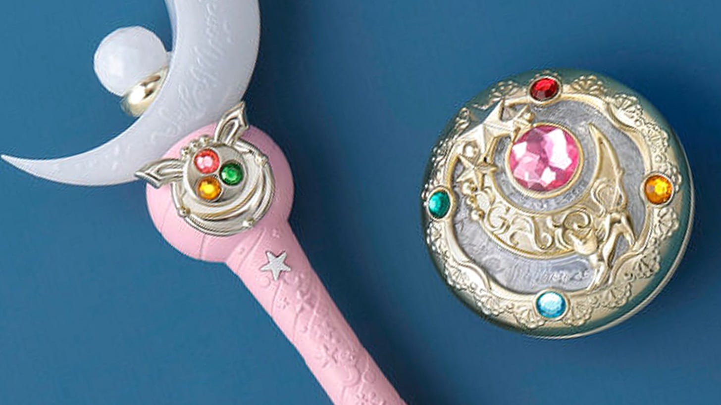 Sailor Moon Shiny Moon Series Moon Stick and Brooch item replicas on a blue background.
