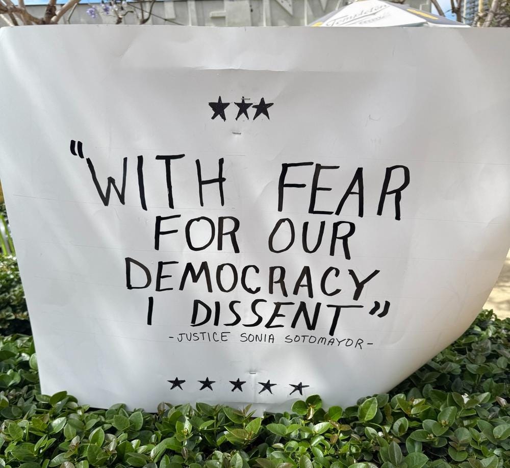 Protest banner quoting Justice Sotomayor: 'With fear for our democracy, I dissent.'