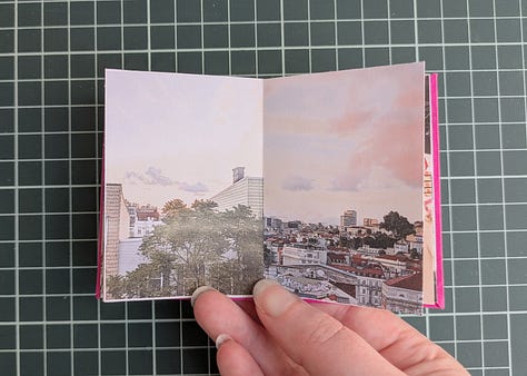 image 1; a small booklet held in a woman's hand, the cover is magenta pink with a black map pin in the center and the words "my two cities" in white. image 2, a woman's hand holds up the booklet, the spread shows to similar photos. the photo on left shows a large flowering tree with bright pink and white blooms behind the tree is a house with faded yellow wood siding, on the right the photo shows a small flowering tree with bright pink and white blooms, behind the tree is an apartment building made of pale yellow stucco. image 3, a woman's hand holds open the booklet, the spread shows two similar photos. the photo on the left shows a gothic archway through the archway we see stairs leading up to trees and a lone figure silhouetted, the photo on the right shows a tall carved stone archway, there are people in the foreground and through the archway we see a pale sky a long statue silhouetted. image 4, a woman's hand holds up the booklet, the spread shows two similar photos, the photo on the left shows various posters and flyers interspersed with graffiti on a dark brown door, the photo on the right shows a wall completely covered in flour pasted flyers and posters. image 5, a woman's hand holds up the booklet, the spread shows two similar photos, the photo on the left shows an iced coffee drink in a plastic cup and a iced blueberry scone on.a black napkin on a rustic wood table with an empty wood cane chair in the background, the photo on the right shows an iced coffee drink in a glass mason chair and a croissant covered in powdered sugar on a black stone tray sitting on a smooth wooden table, there's am empty white woven chair in the background. image 6, a woman's hand holds up the booklet, the spread shows two similar photos, the image on the left shows the tops of trees and small homes and flat top apartment buildings, the sky is pale yellow and blue and a few dark blue clouds dot it, the image on the right shows the tops of white homes and apartments with dark red terracotta shingles on the roofs, the sky is pale blue and yellow with dark blue and bright pink clouds. image 7, a woman's hand holds open the booklet, the spread shows two similar photos, the photo on the left shows a white gallery wall featuring many framed art works in varying sizes and shapes. a long man in a khaki shorts and blue shirt stands to the left looking up at the artwork, the photo on the right shows a large beige curved wall featuring many hanging loose canvases painted in bright warm colors, a lone man stands to the right in all black looking up at the canvases. image 8, a woman's hand holds open the booklet, the spread shows two similar photos, the photo on the left is a woman's left hand holding an ice cream cone with two scoops, the ice cream is white with brown flecks, the background shows a blurry concrete sidewalk, the photo on the right show's a woman's left hand holding an ice cream cone, the ice cream is dark chocolate and artfully arranged into petals to resemble a rose, the background is a blurry tiled sidewalk in white and black. image 9, a woman's hand holds open the booklet, the spread is two similar photos, the photo on the left is a bright blue sky with fluffy white clouds over the NYC skyline, the photo on the right shows the sky in the exact same bright blue shade with white fluffy clouds that seem to connect with the clouds from the photo on the left, the buildings at the bottom of the photo are white with bright red terracotta roofs