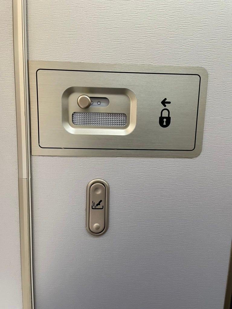 Airplane cigarette ash tray on back of bathroom door Airplane cigarette ash tray on back of bathroom door