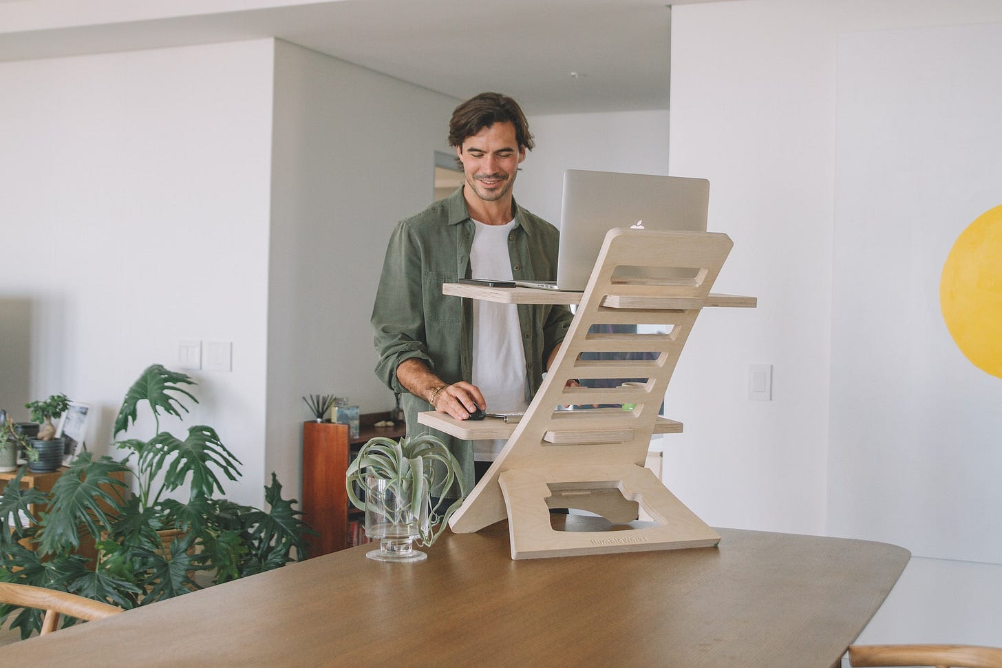 man working at a standing desk converter man working at a standing desk converter