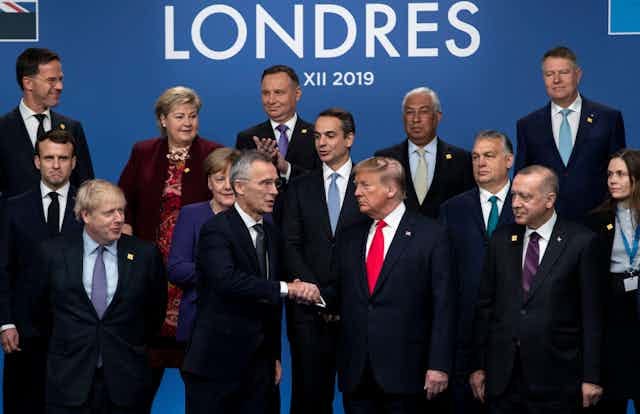 Donald Trump in middle of picture, at Nato meeting in 2019, surrounded by Nato leaders. Donald Trump in middle of picture, at Nato meeting in 2019, surrounded by Nato leaders.