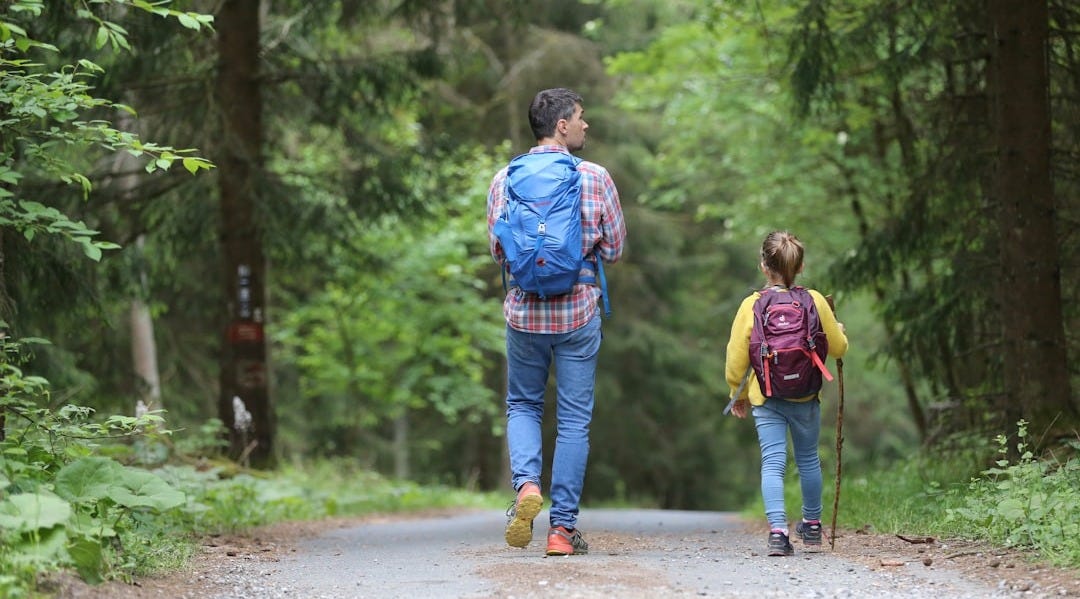 man in blue jacket and blue denim jeans walking on dirt road during daytime man in blue jacket and blue denim jeans walking on dirt road during daytime