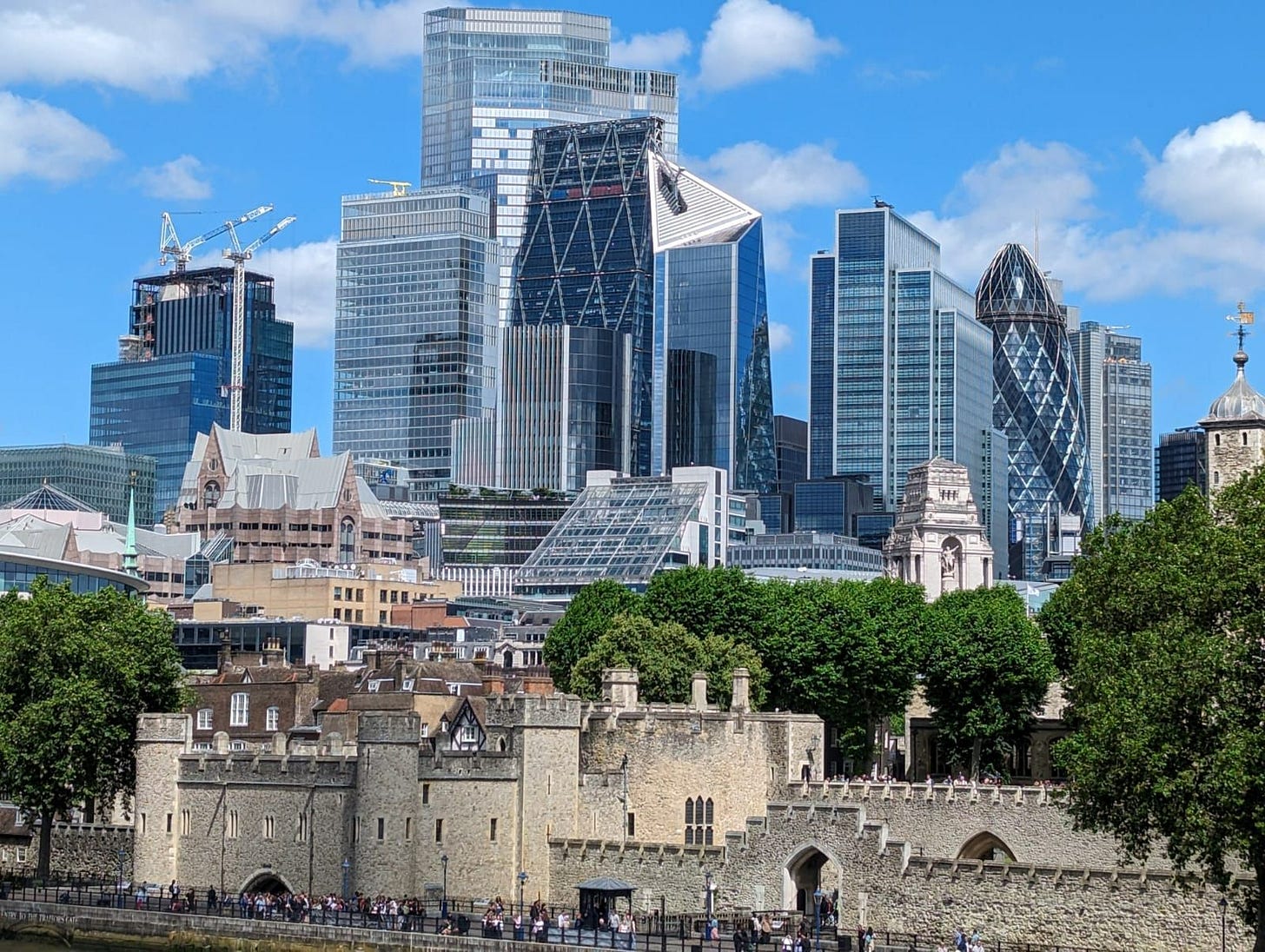 A view of the Tower of London, with the metropolis of the city behind.