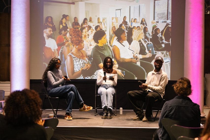 Mitzi Okou speaking on a stageThree Black creatives speaking on stage ā two women, one man ā which was part of an event organised by Where Are The Black Designers Mitzi Okou speaking on a stageThree Black creatives speaking on stage ā two women, one man ā which was part of an event organised by Where Are The Black Designers