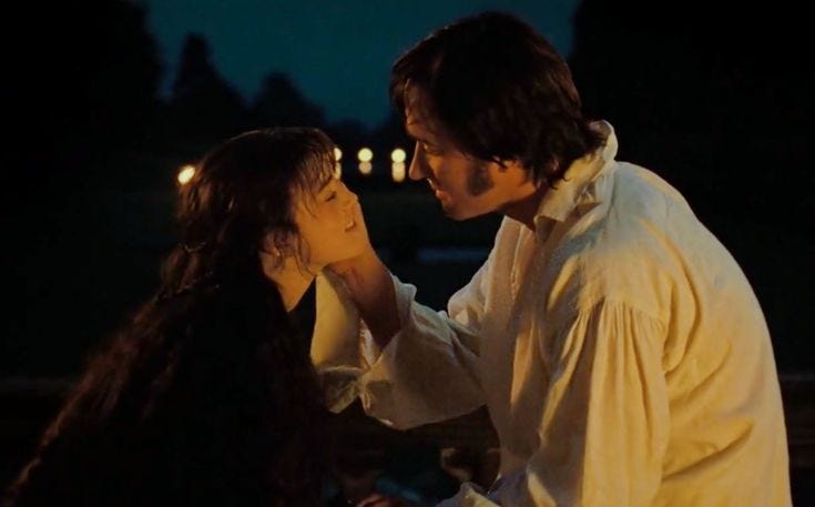 This may contain: two people standing next to each other in the dark