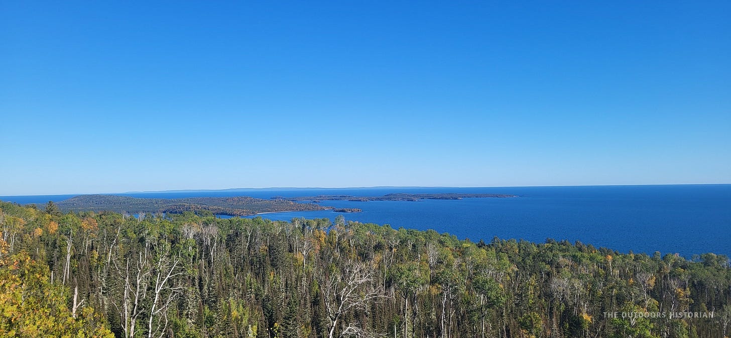 A high-angle scenic view looking down at the cluster of forested Suzy Islands in Lake Superior.