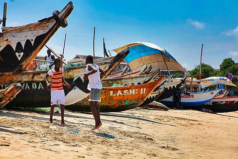Canoes, boys, girls, pier at James in Accra, Ghana