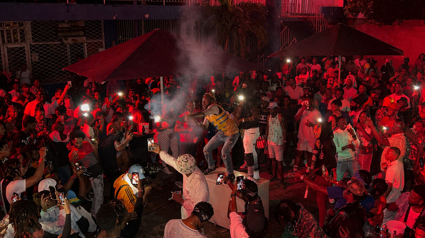 A dancehall session in full motion, where music, movement and community converge under the glow of Kingston’s night, capturing the raw energy and unity that define the inner-city heartbeat