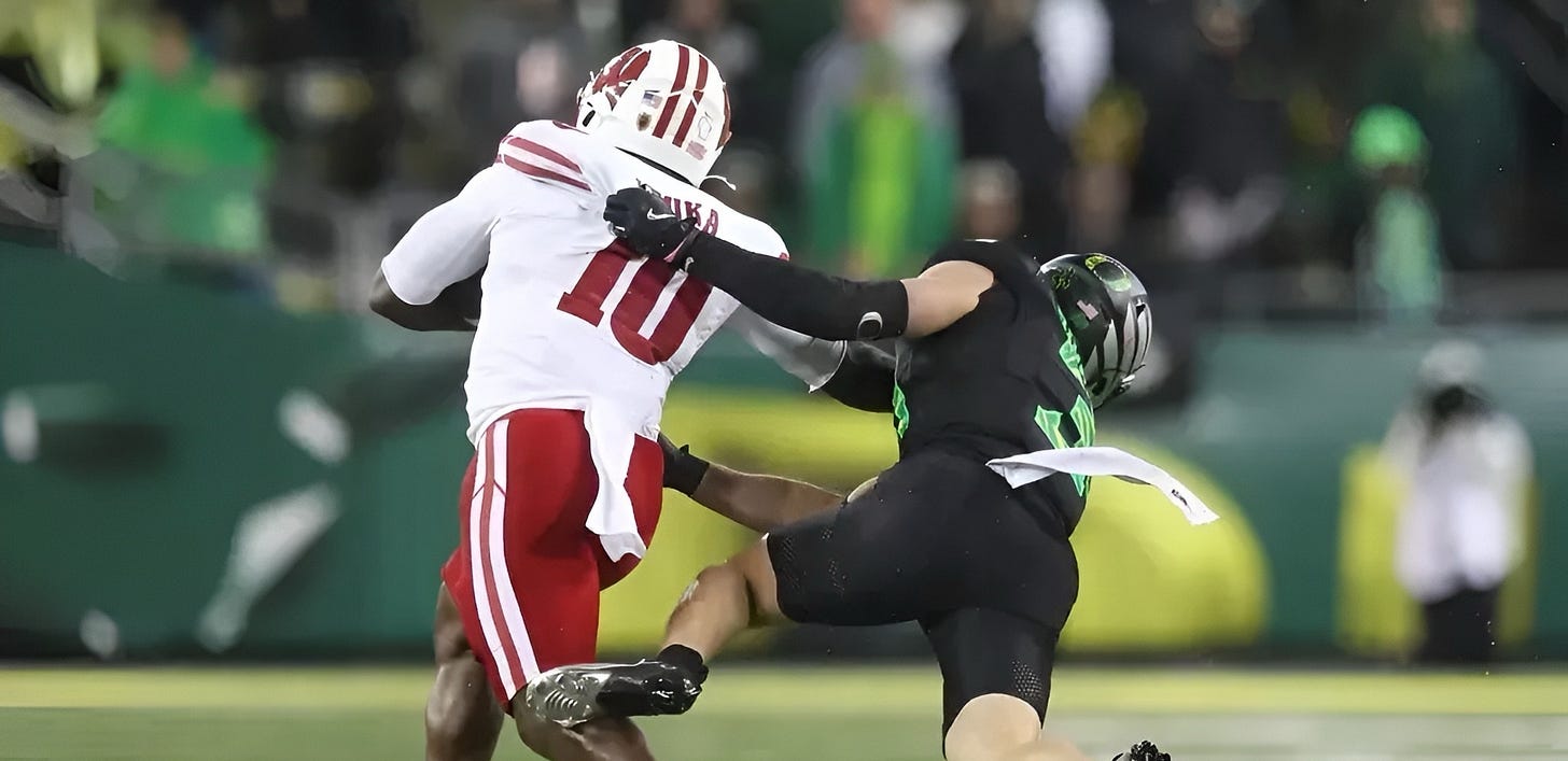 Wisconsin Badgers running back Gideon Ituka runs the ball during a game against Oregon at Autzen Stadium. Wisconsin Badgers running back Gideon Ituka runs the ball during a game against Oregon at Autzen Stadium.