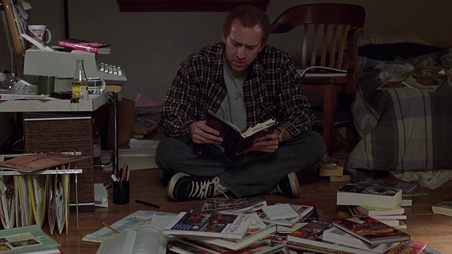Adaptation. | Still features Nicolas Cage as Charlie Kaufman surrounded by books about screenwriting.
