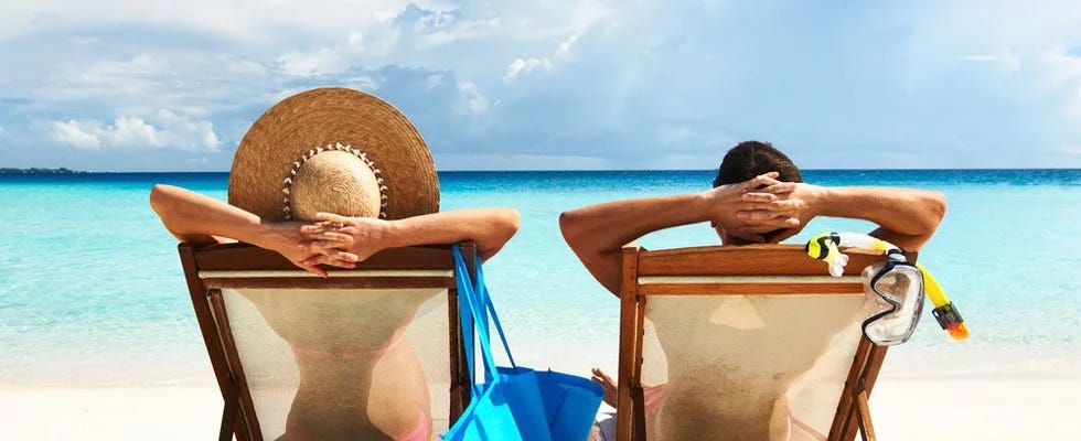 Couple on beach getting sun exposure