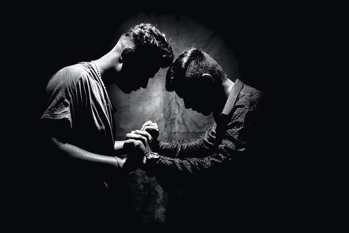 Free Grayscale Photo of Two Men Holding Hands Stock Photo