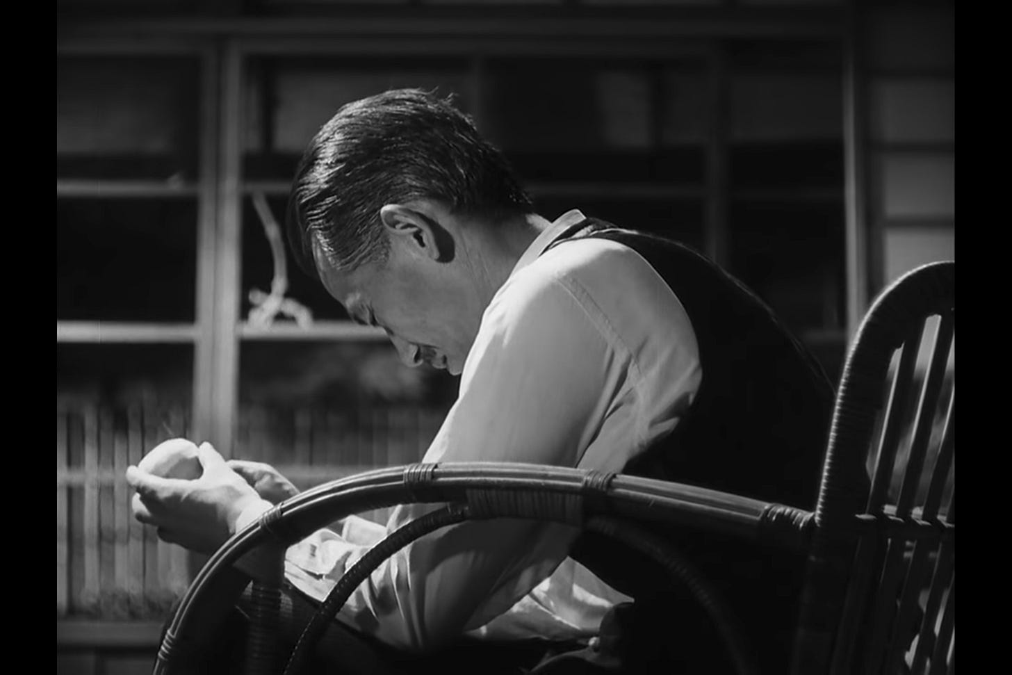 What the Peel Knows: Professor Somiya sits alone in his house, peeling an apple. The peel breaks, and he lowers his head in a gesture of profound loss. What the Peel Knows: Professor Somiya sits alone in his house, peeling an apple. The peel breaks, and he lowers his head in a gesture of profound loss.