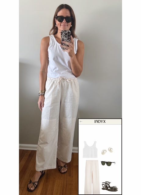 Woman wearing white scoop tank, ivory poplin pants, black strappy sandals, and chunky gold earrings. Woman wearing white scoop tank, ivory poplin pants, black strappy sandals, and chunky gold earrings.