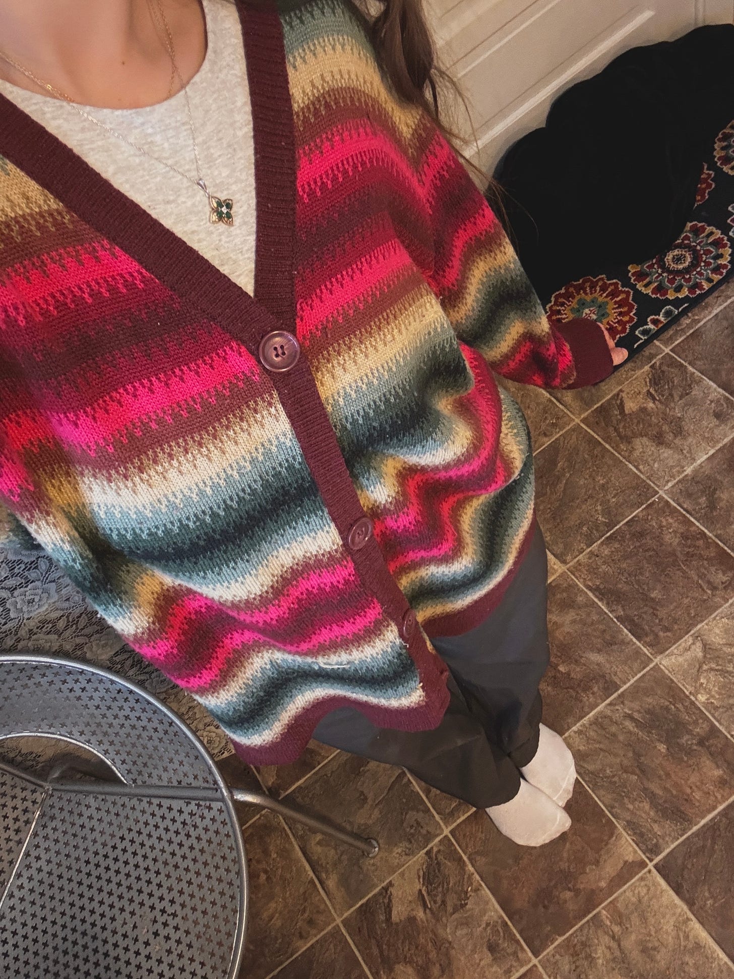 Image showing narrator wearing colorful sweater and black pants