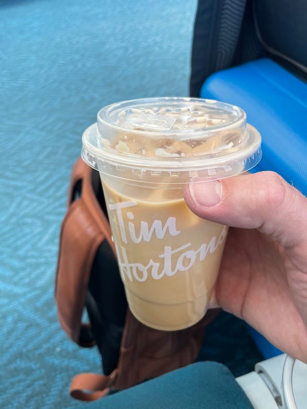 A Tim Horton's cup with an iced coffee in it