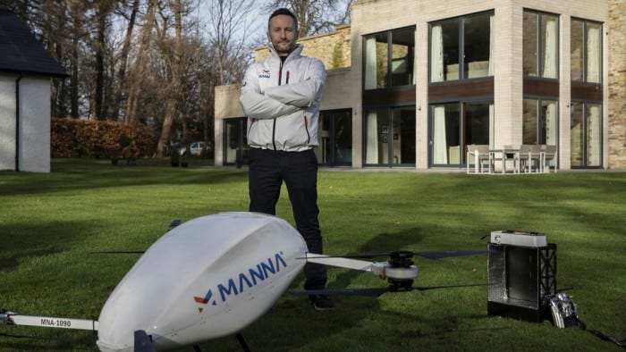 Manna founder Bobby Healy standing next to a drone