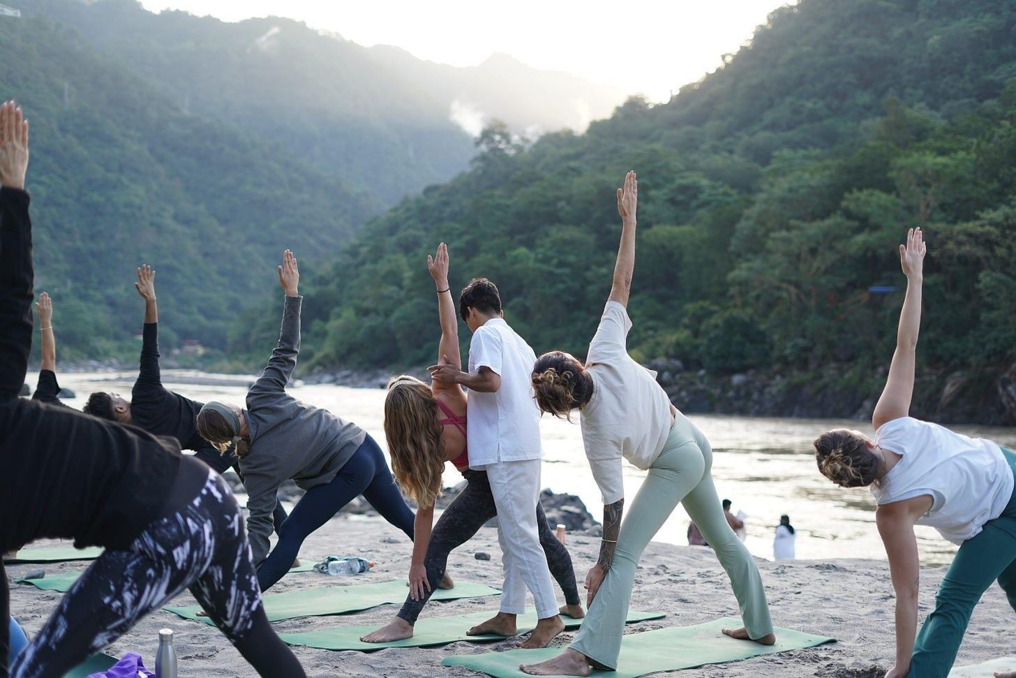 A group of people doing yoga on the beach
Description automatically generated A group of people doing yoga on the beach
Description automatically generated