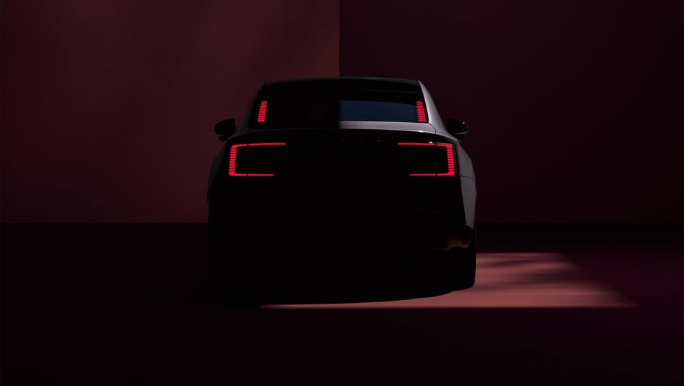 rear view of a car illuminated by red taillights against a dark background