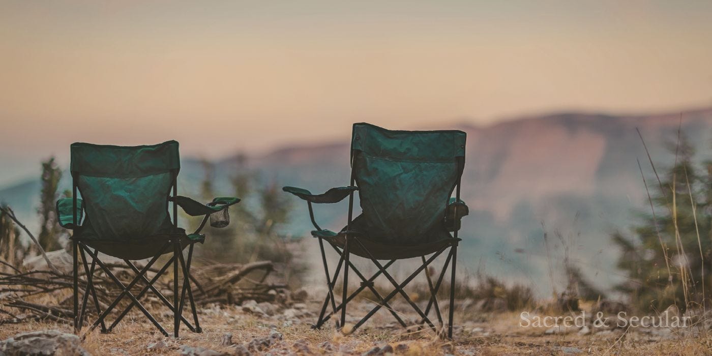 Two empty chairs positioned slightly apart outdoors, facing a soft, hazy landscape in warm morning light, suggesting distance and quiet reflection. Two empty chairs positioned slightly apart outdoors, facing a soft, hazy landscape in warm morning light, suggesting distance and quiet reflection.