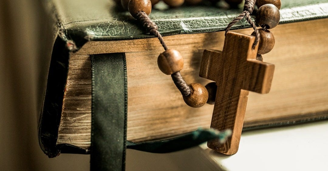 brown tesbih prayer beads on black book
