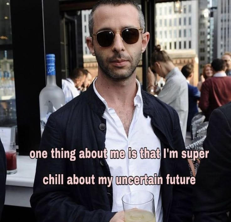 This may contain: a man holding a drink in his right hand