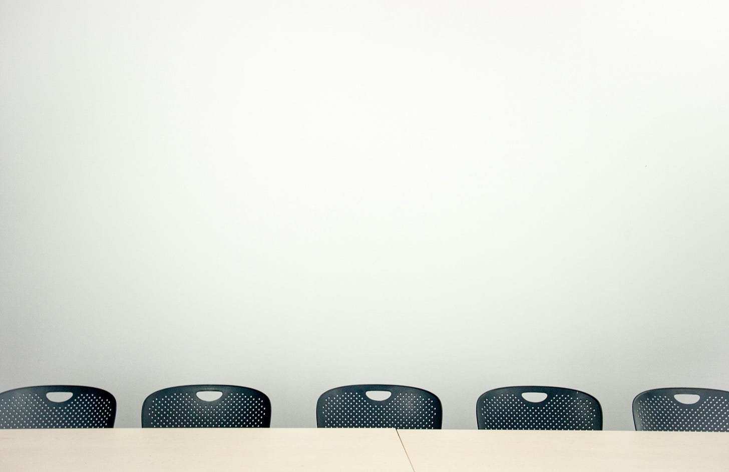 A table and chairs in a white conference room. A table and chairs in a white conference room.