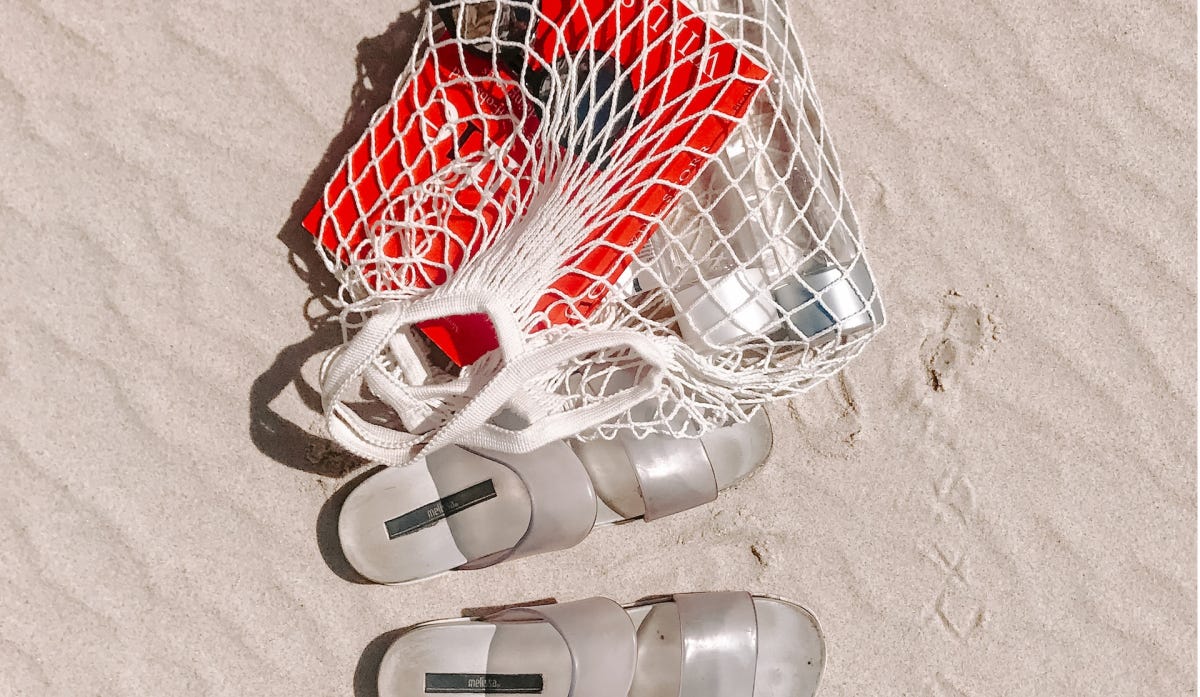 Books in summer bag on the beach