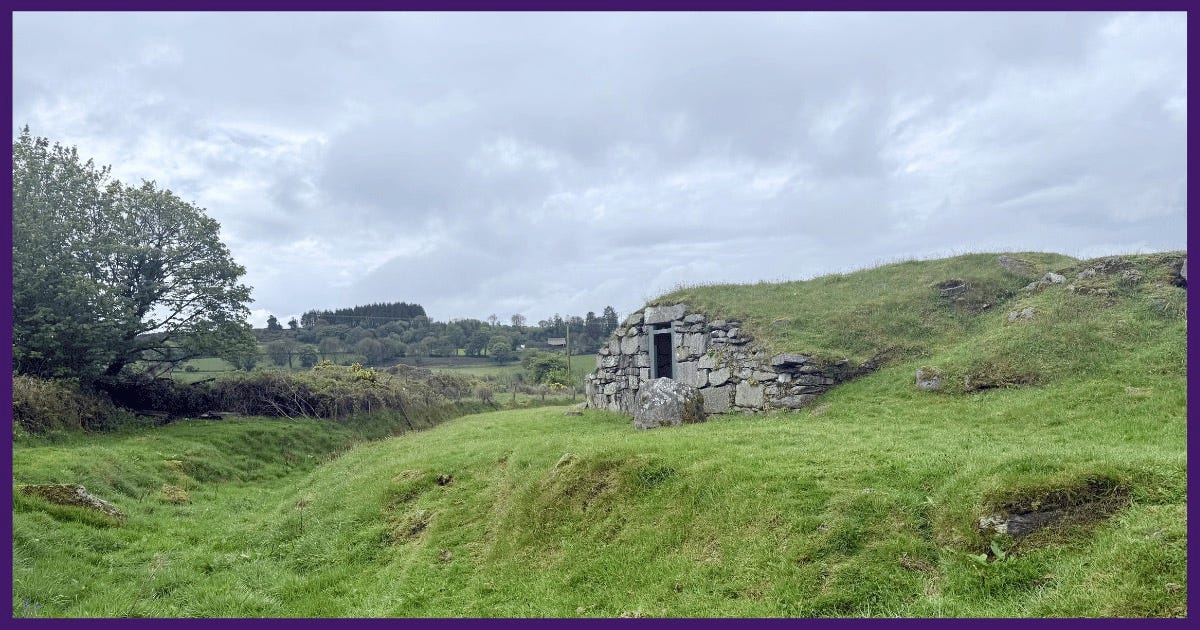 stone facade of a ringfort set in a green pasture