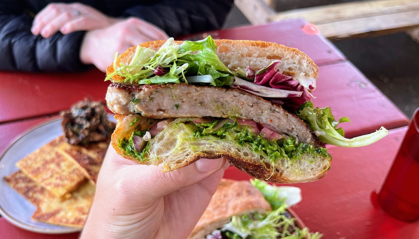 Hand holding salciccia from Sorbu Paninoteca