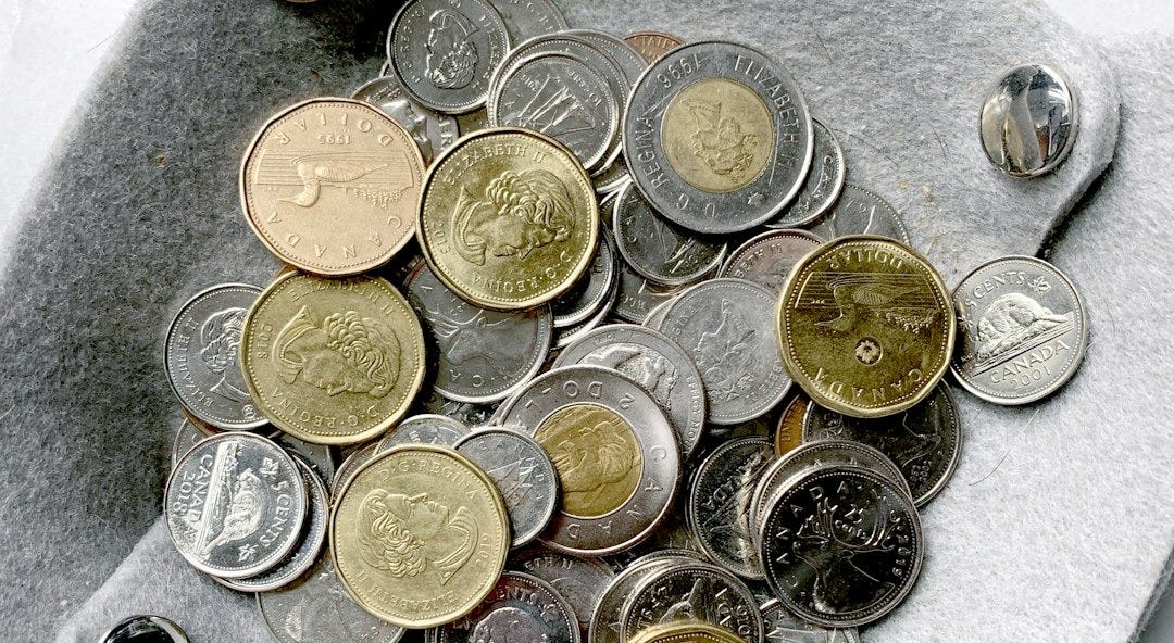 gold and silver round coins on gray surface gold and silver round coins on gray surface