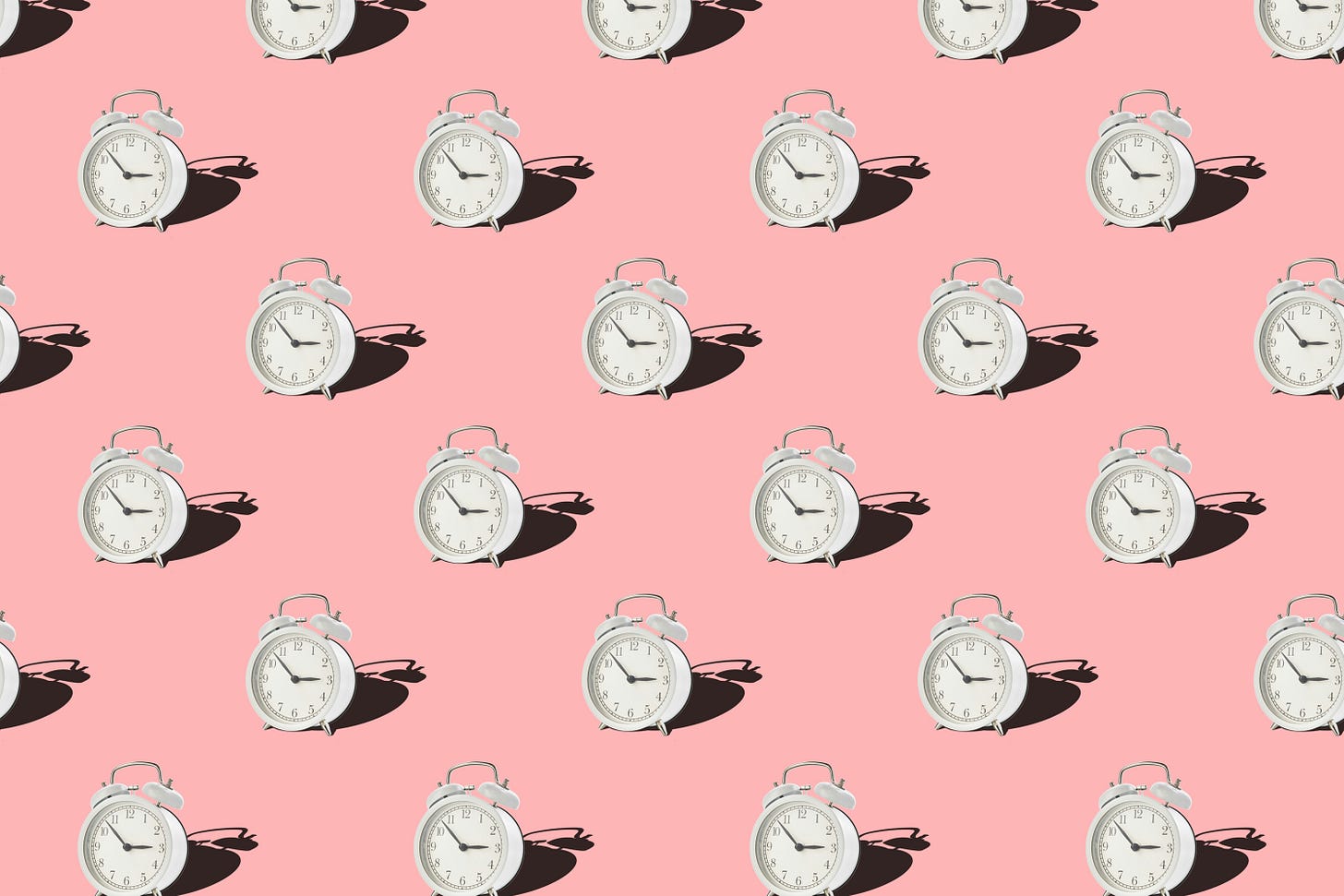 A pattern of small white round alarm clocks on a pink/orange background