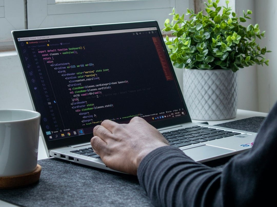 person using macbook pro on table