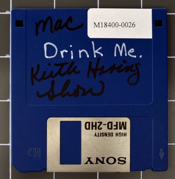 Haring, K. (circa 1987) [Blue 3.5in floppy disk with "Drink Me" written on label]. The Timothy Leary papers (MssCol 18400). New York Public Library. New York: NY.