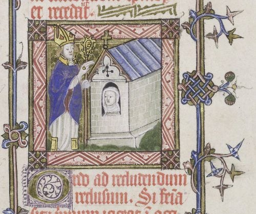 A colorful medieval illumination from a 15th-century English pontifical. On the left, a bishop wearing a mitre and holding a pastoral staff extends a hand in blessing. On the right, an anchoress looks out from a small window of a miniature stone church building, symbolizing her anchorhold. Below the scene, Latin liturgical calligraphy is written in black and red ink.